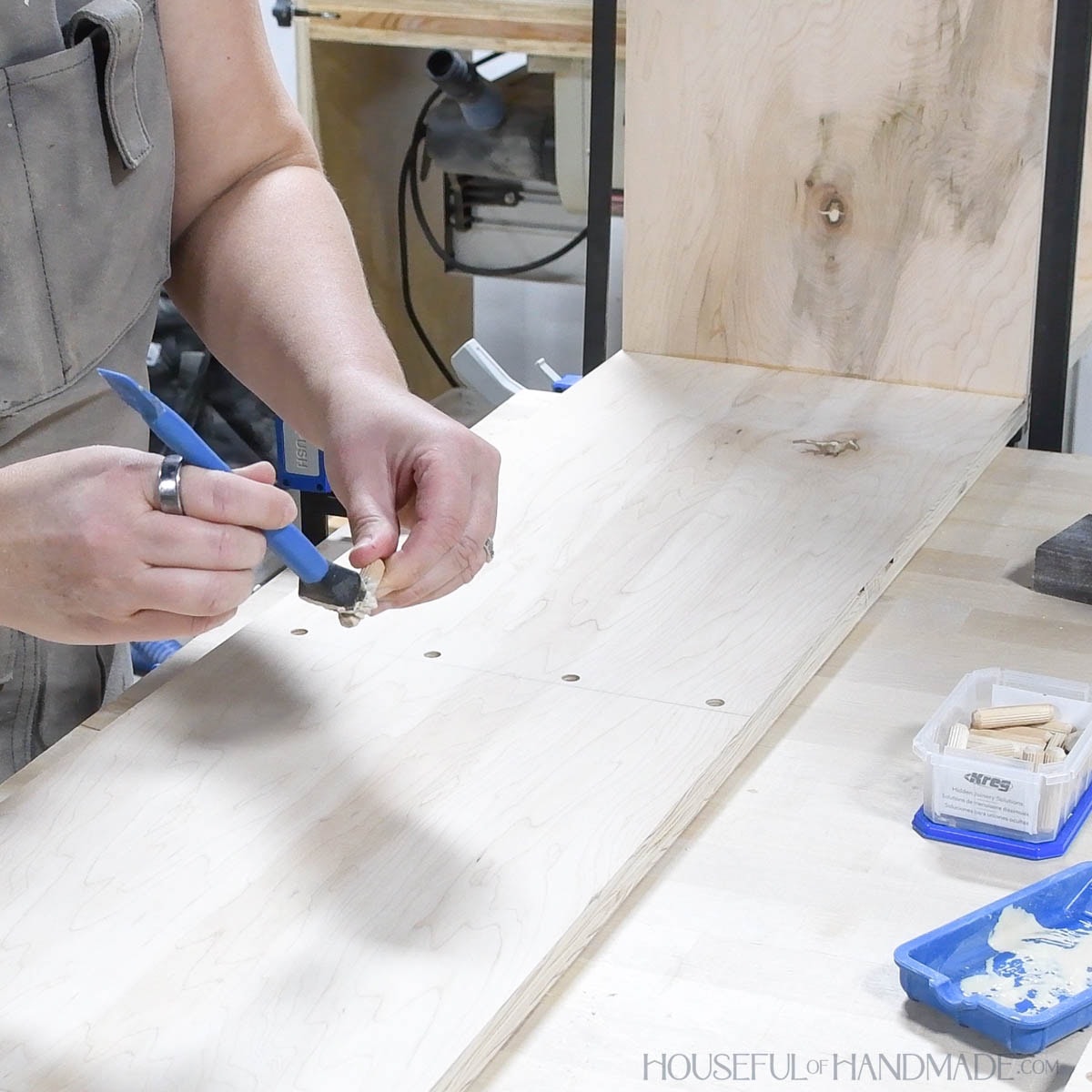 Painting glue on dowel pins with a silicone glue brush. 