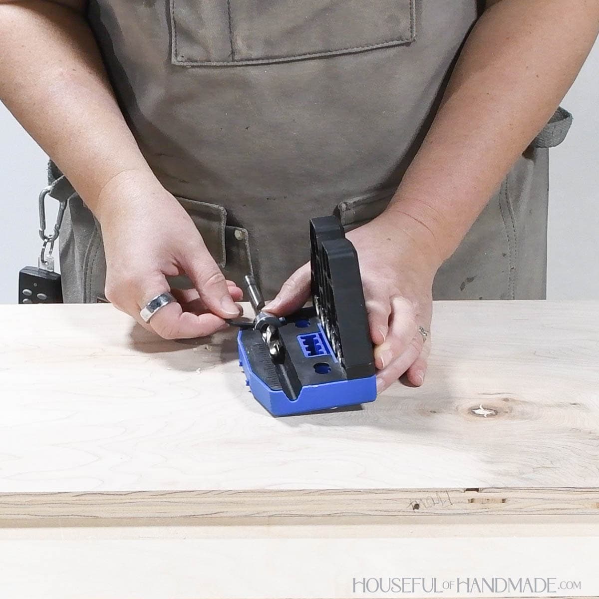 Adjusting the stop collar on the drill bit for the dowel jig. 