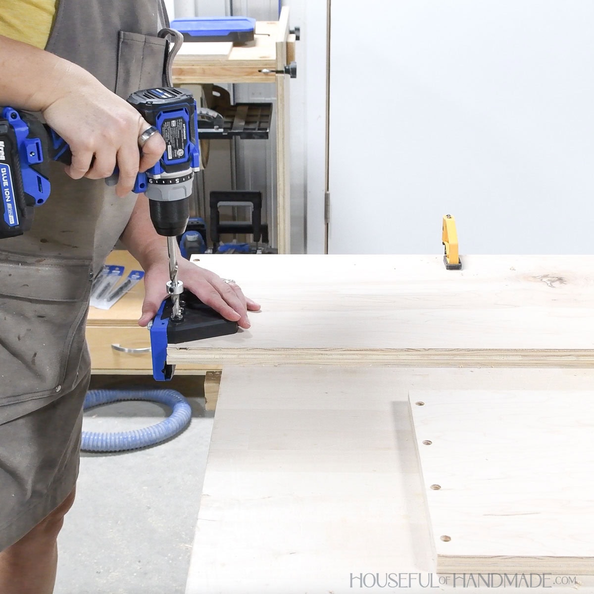 Drilling holes for dowel joinery in plywood with a jig. 
