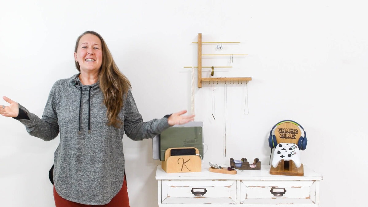 Kati standing next to table full off DIY gifts built from wood scraps. 