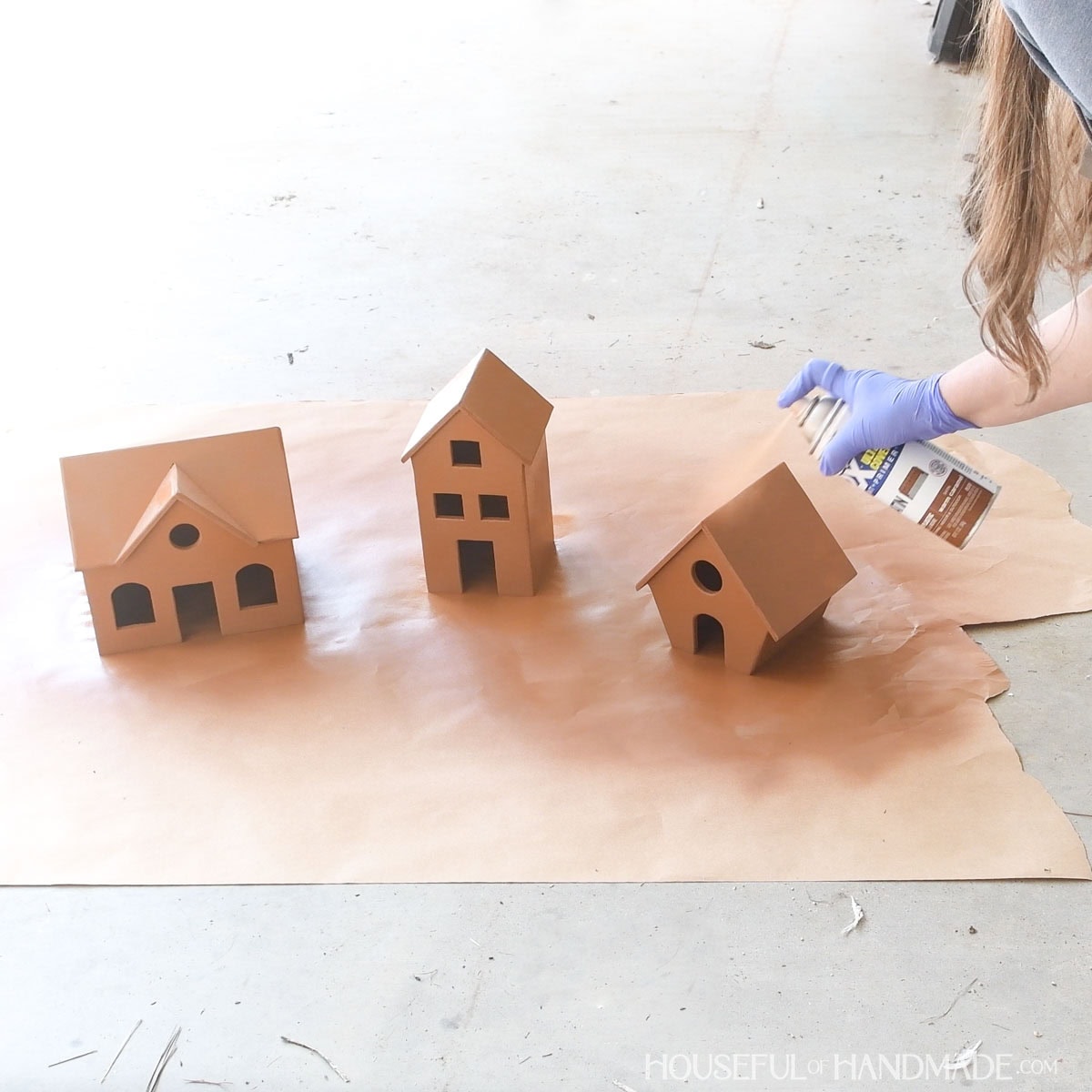 Spray painting houses to look like gingerbread. 