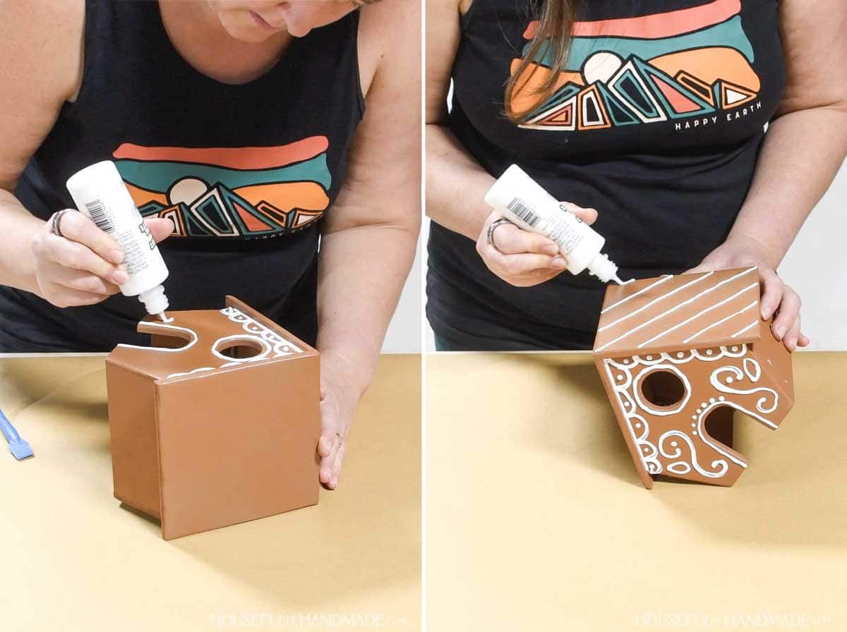 Decorating wood gingerbread houses with white puff paint. 