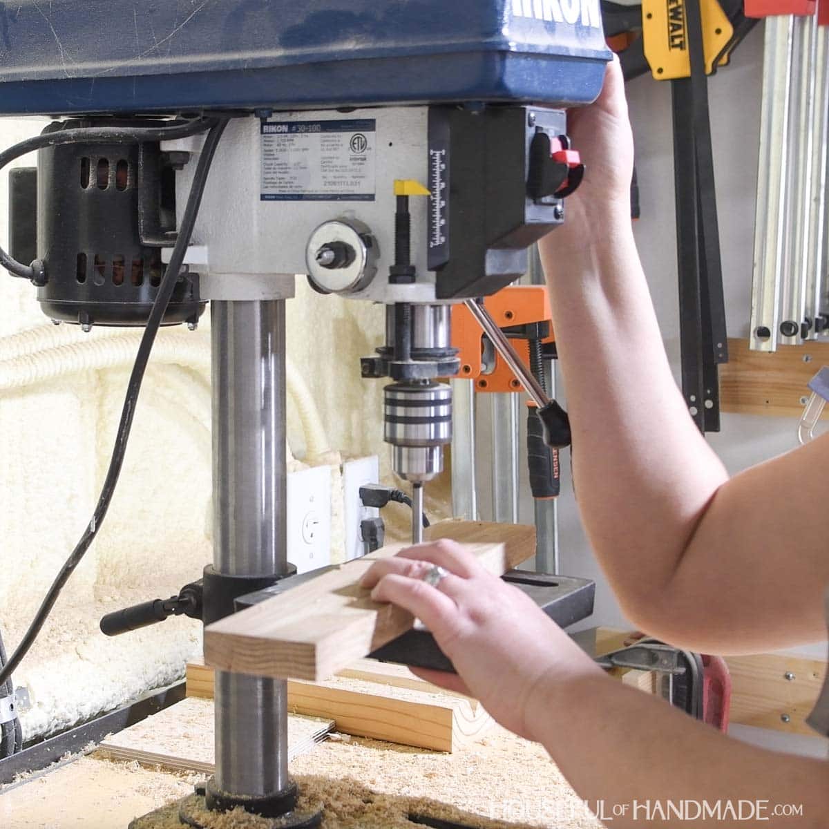 Drilling 1/4" holes with a drill press.