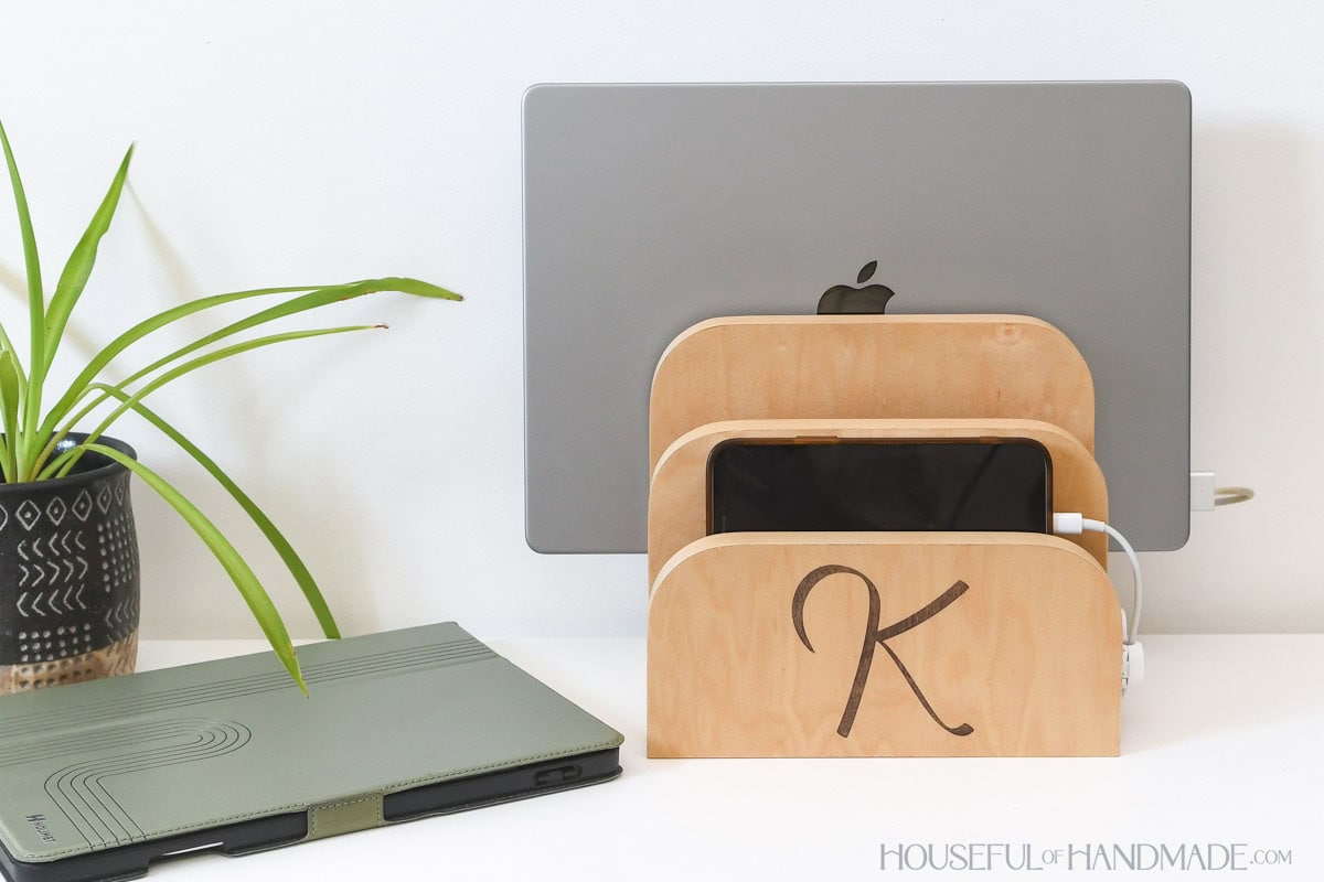 Wood charging station for 3 devices with tablet sitting next to it.