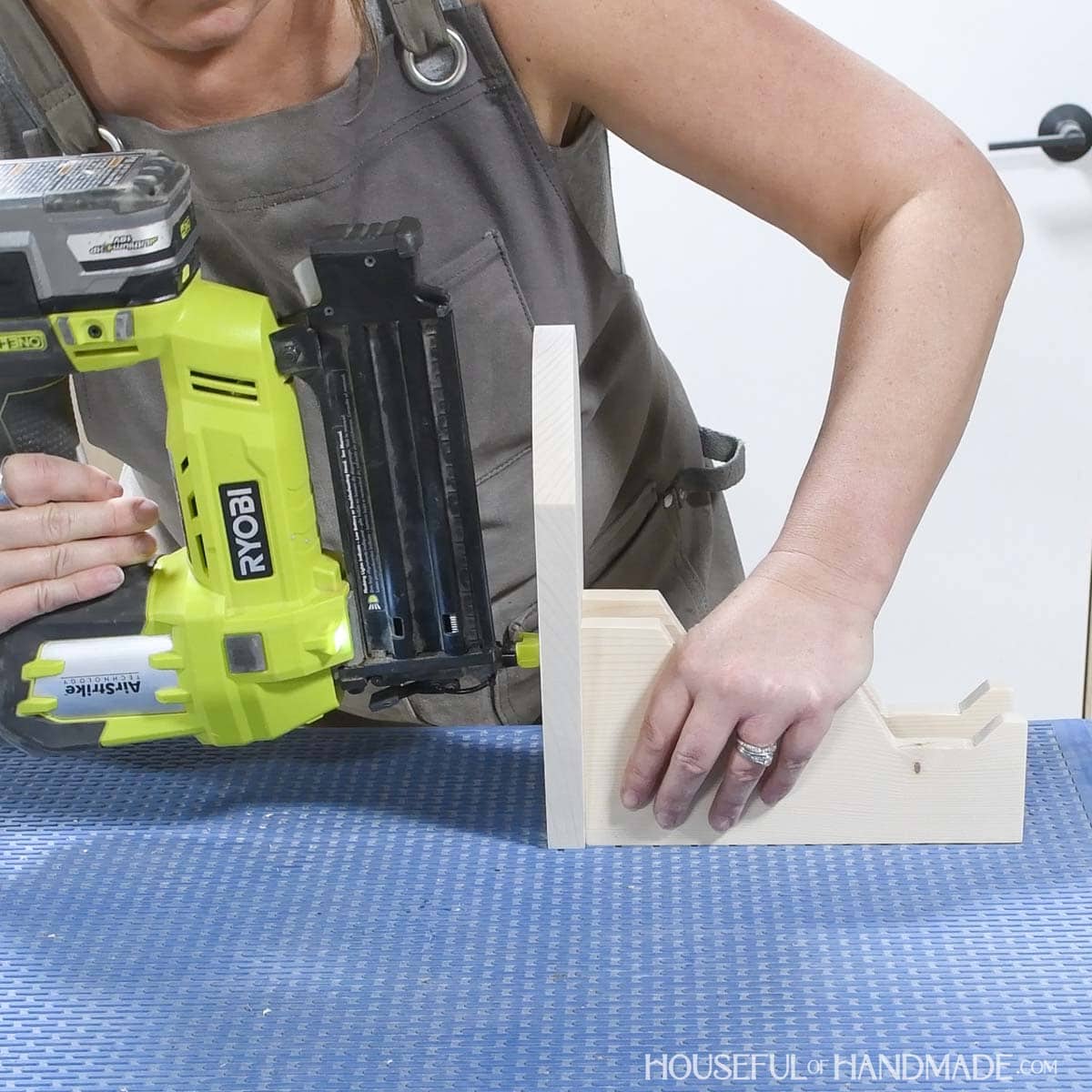 Attaching controller holders to headphone stand with brad nails.