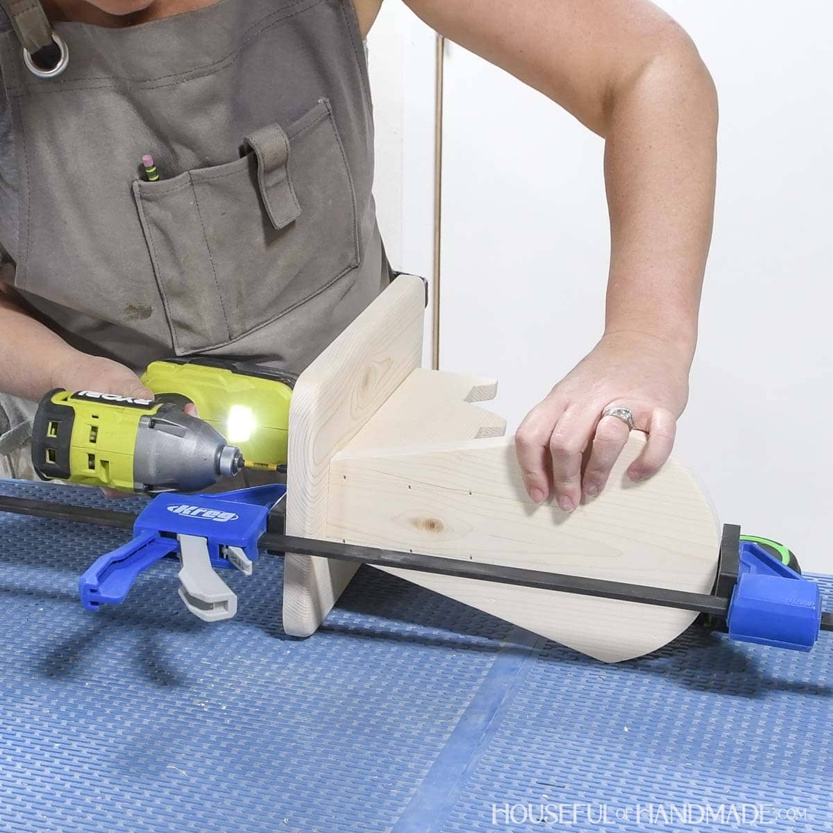 Clamping the top to the base and securing with wood screws.
