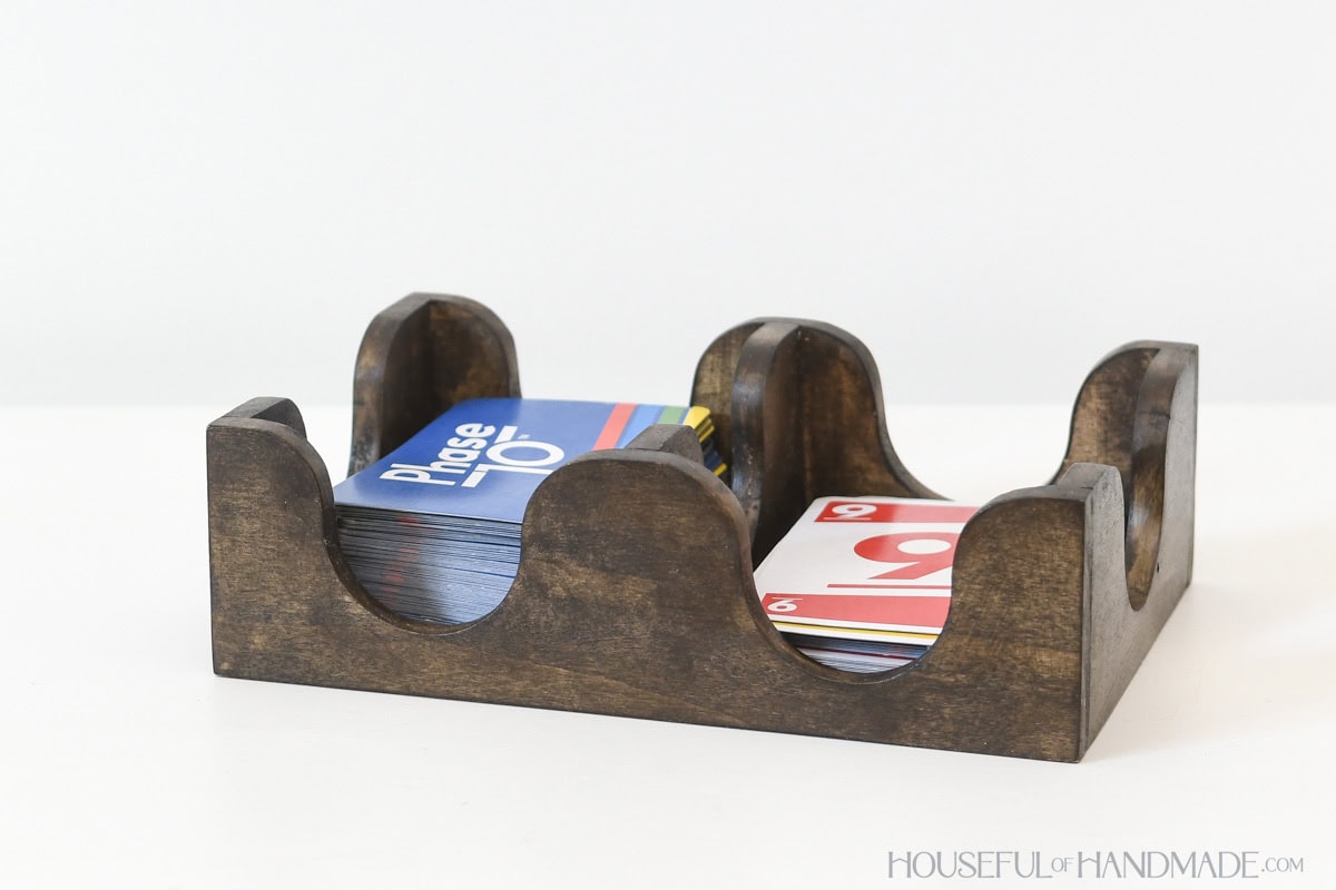 Wood card tray with wavy sides to allow easy access to playing cards. 
