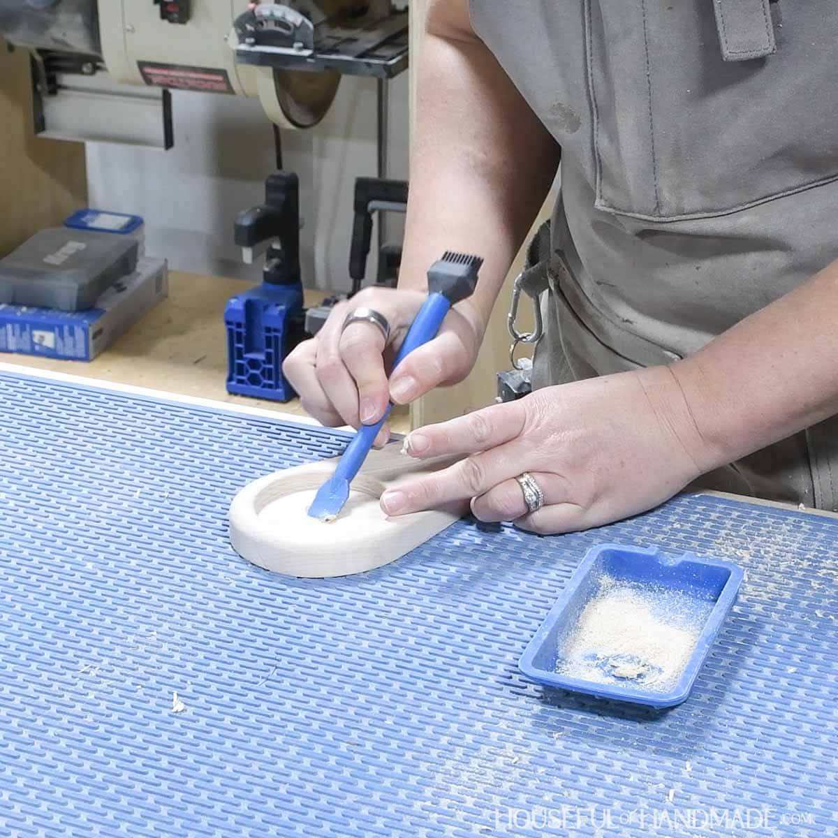 Filling in the hole in the center with glue and sawdust.