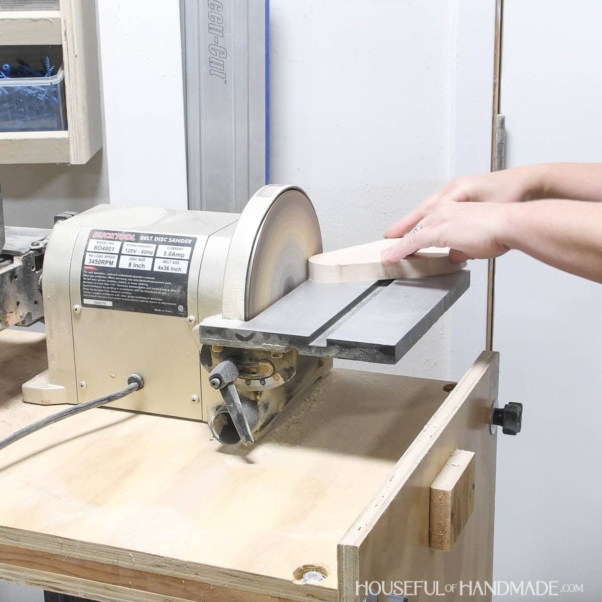 Sanding the curve with a disc sander.
