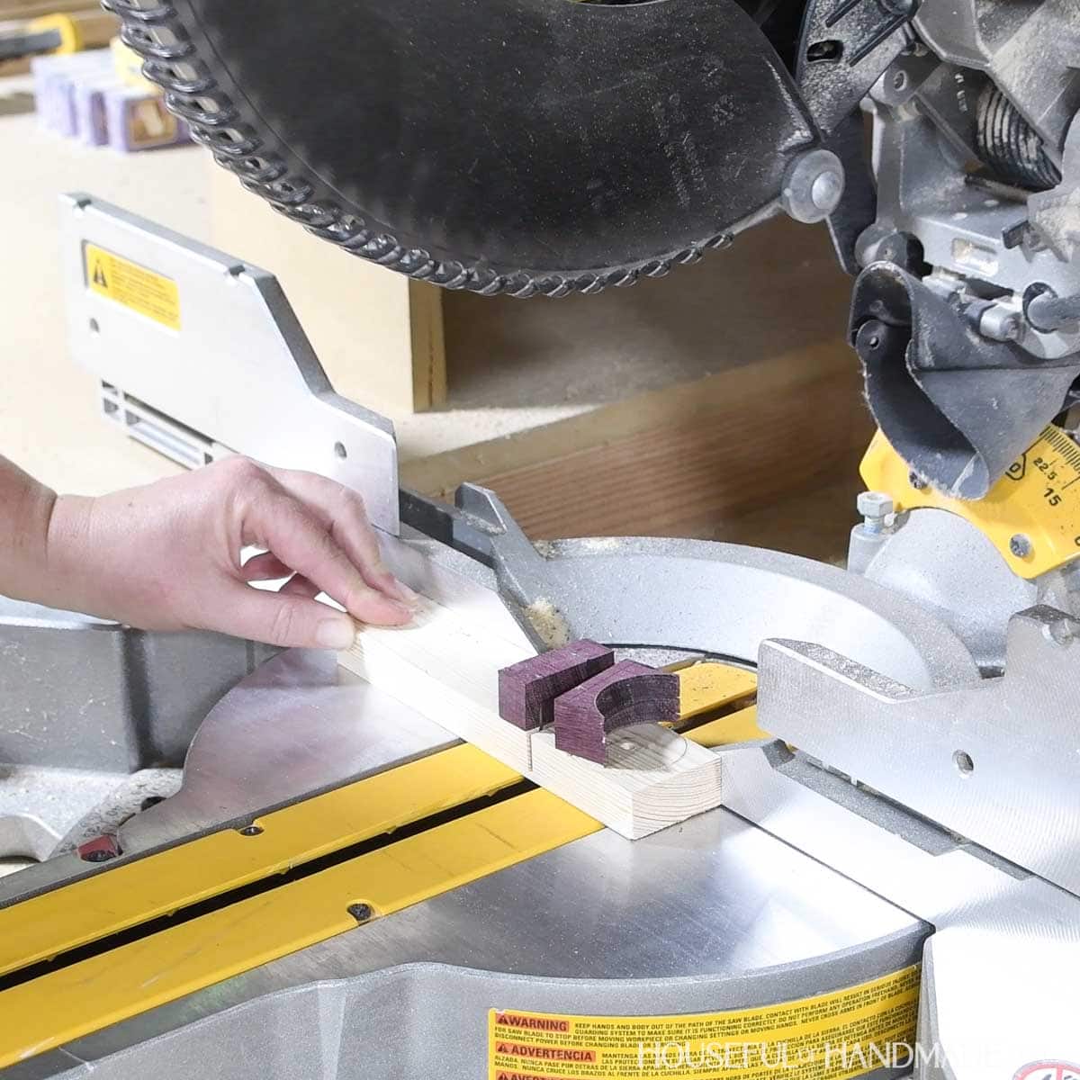 Cutting the scrap on a miter saw.