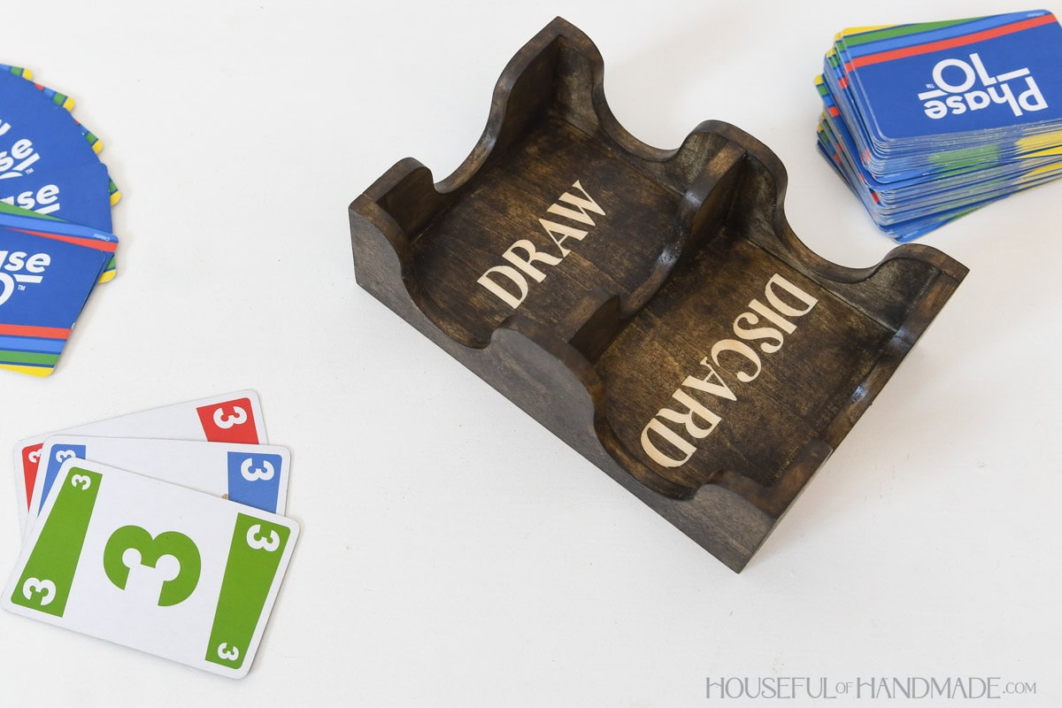 Wood card deck holder with words Draw and Discard stained into the bottom. 