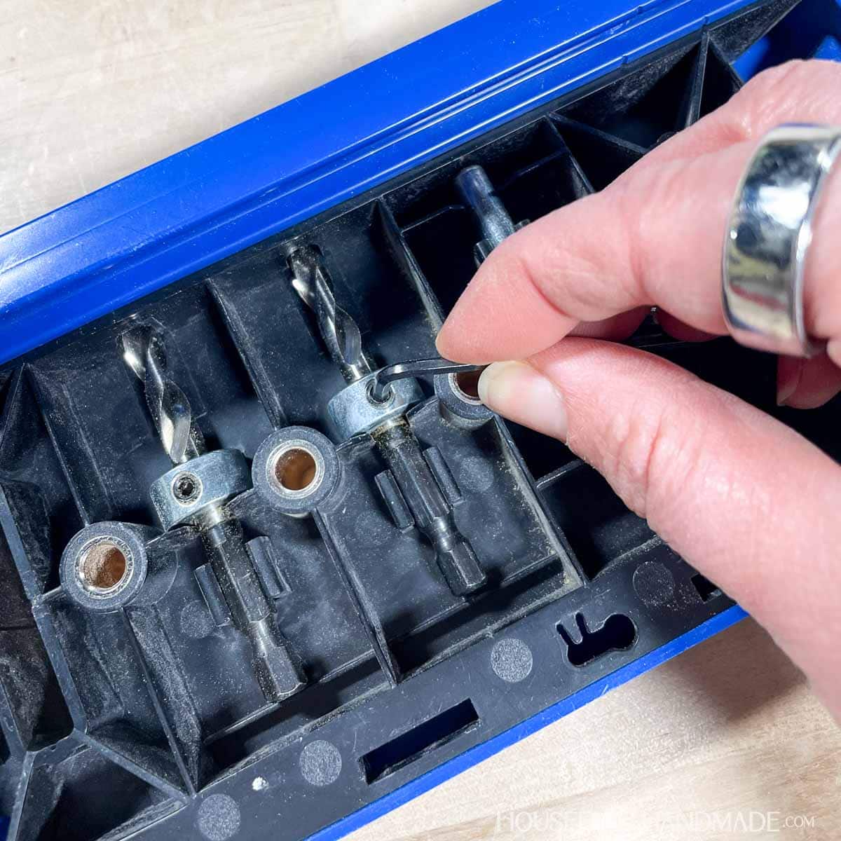 Adjusting the stop collar on the shelf pin jig drill bit.