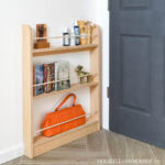 Plywood behind the door shelf with three shelves.
