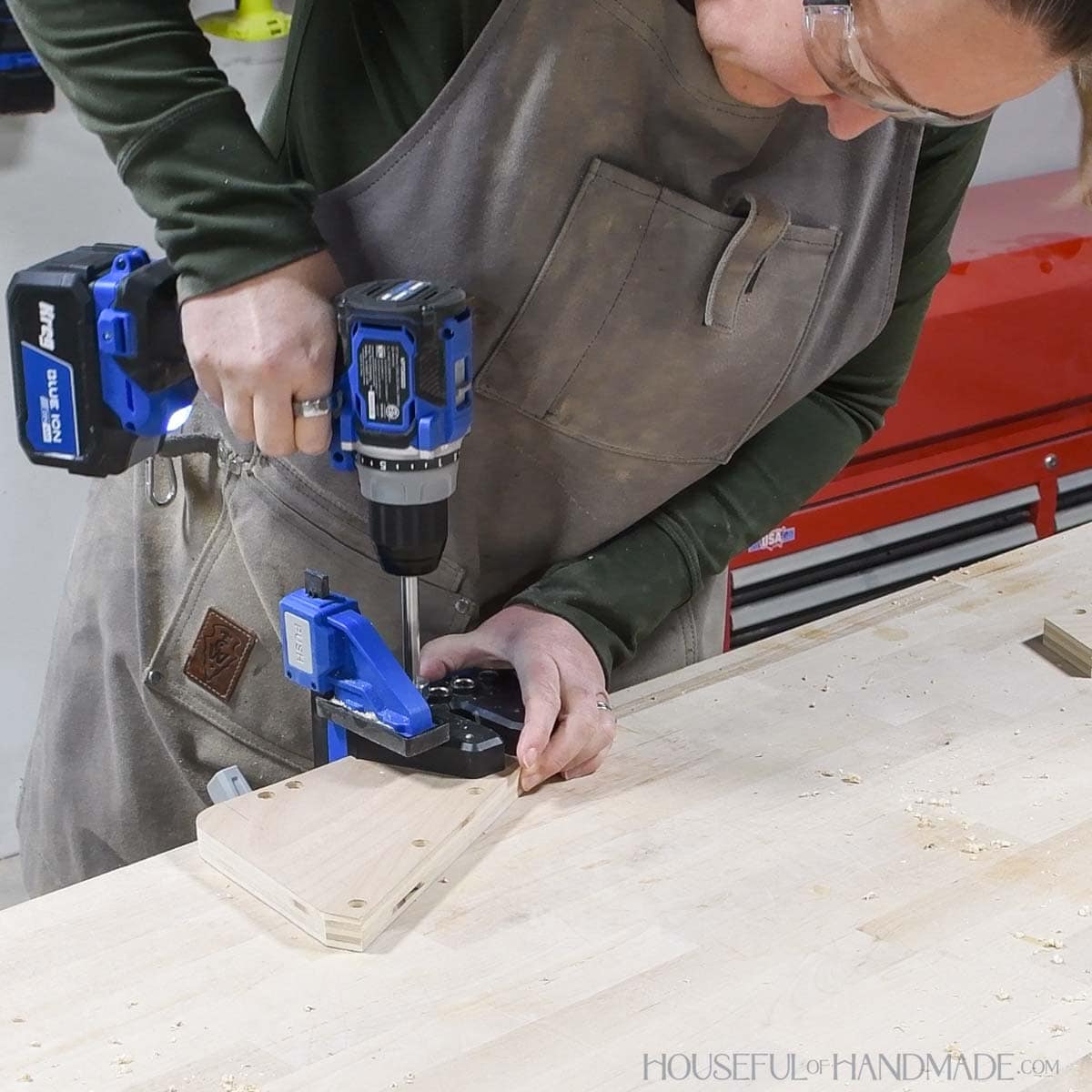 Drilling dowel pin holes on the side board with the Kreg Dowel jig. 