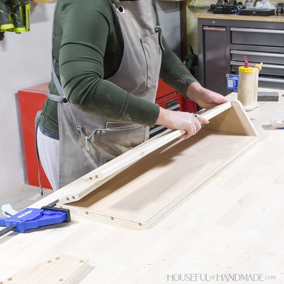 Attaching the front rails and back to one side board with dowel pins and glue. 