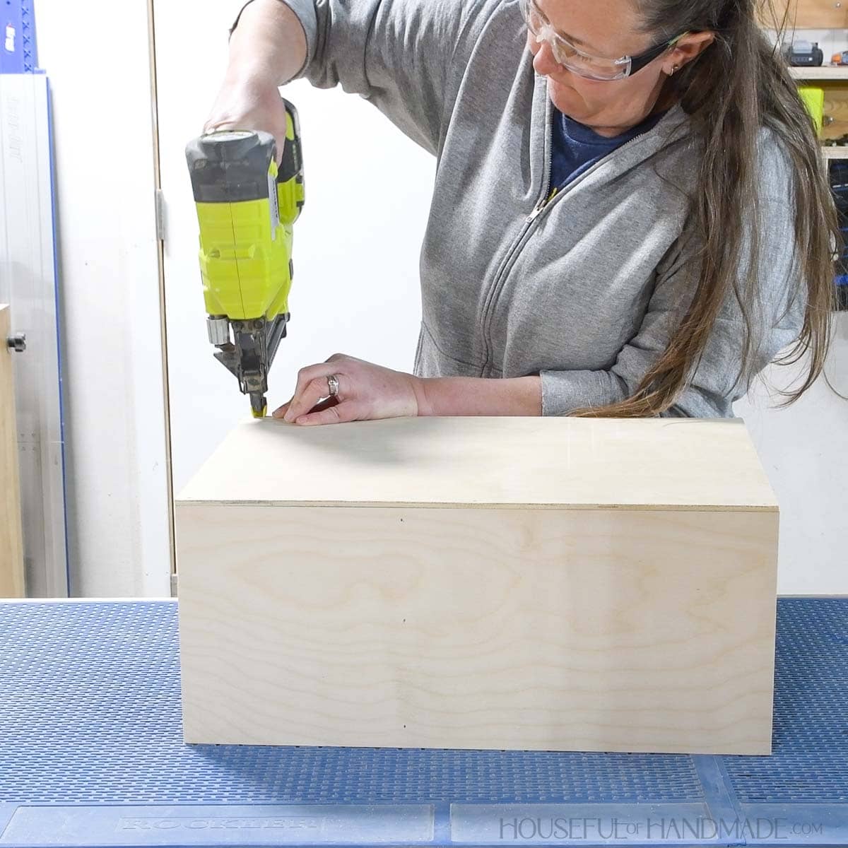 Nailing a 1/4 plywood back on the shelf. 