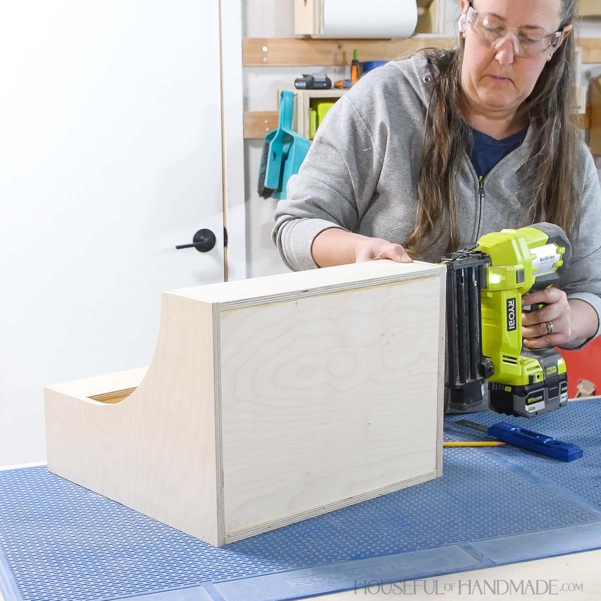 Attaching the bottom to the drawer with nails. 