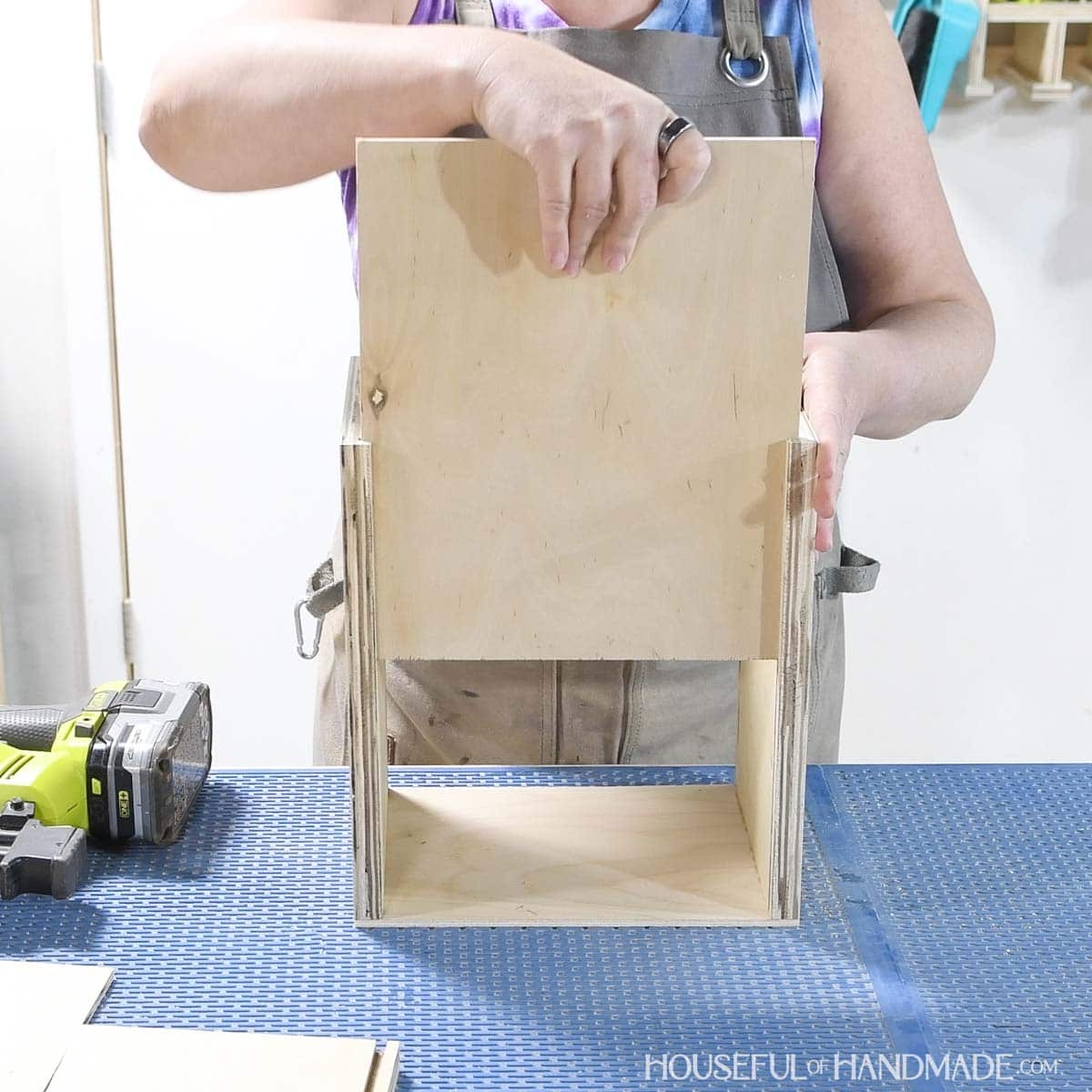 Sliding the bottom into the seed storage box.