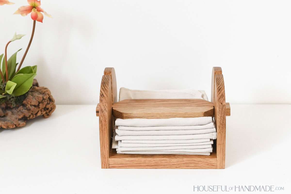 Simple napkin holder with weight on top holding napkins flat. 