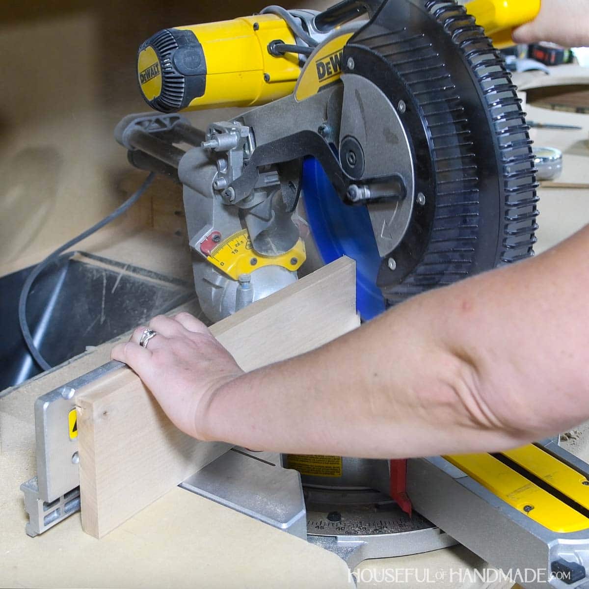 Cutting a bevel on the end of a board with a miter saw. 