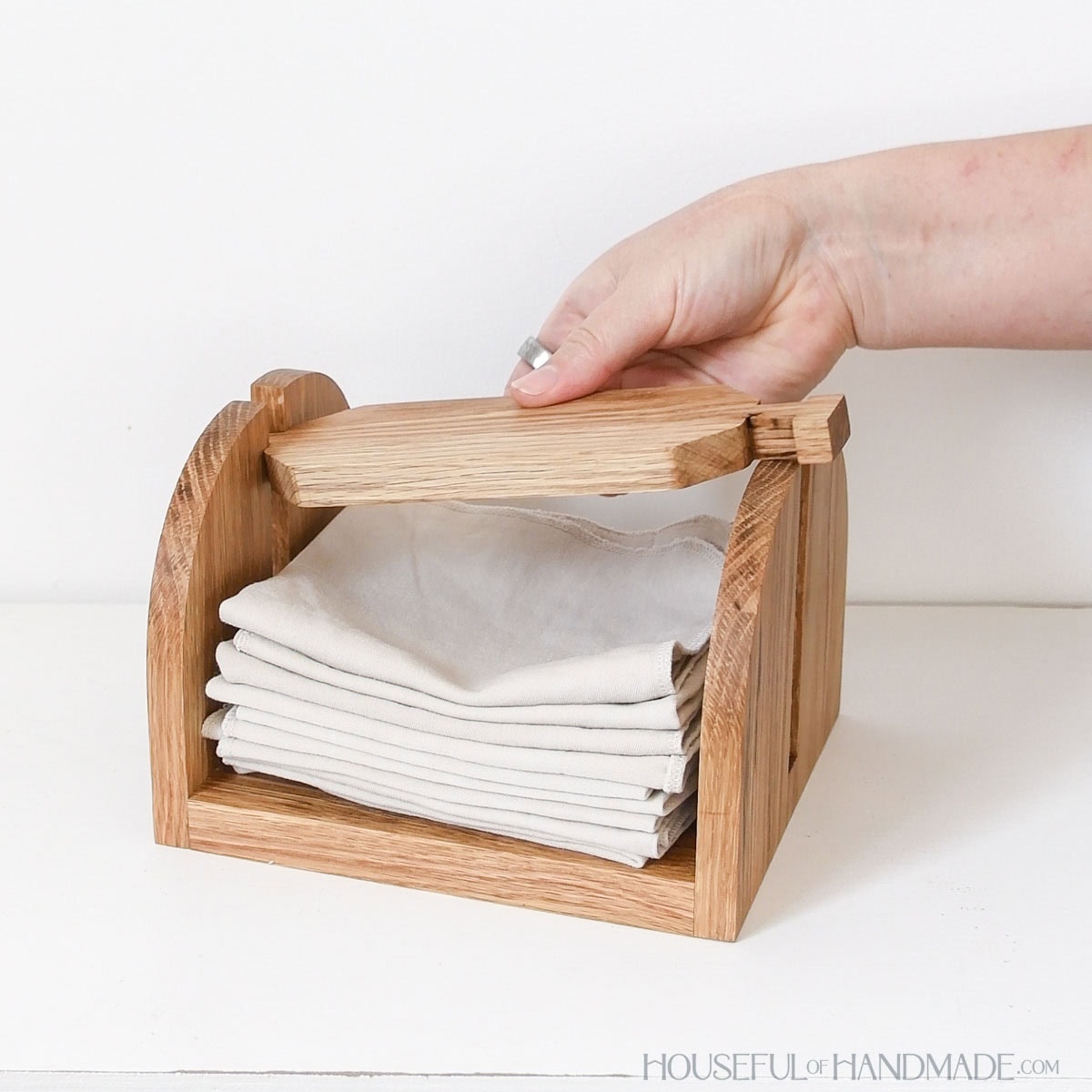 Placing napkins inside the finished wood napkin holder. 