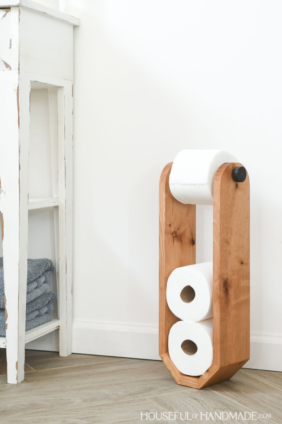 Modern toilet paper stand with room to store 3 extra toilet paper rolls made from alder. 