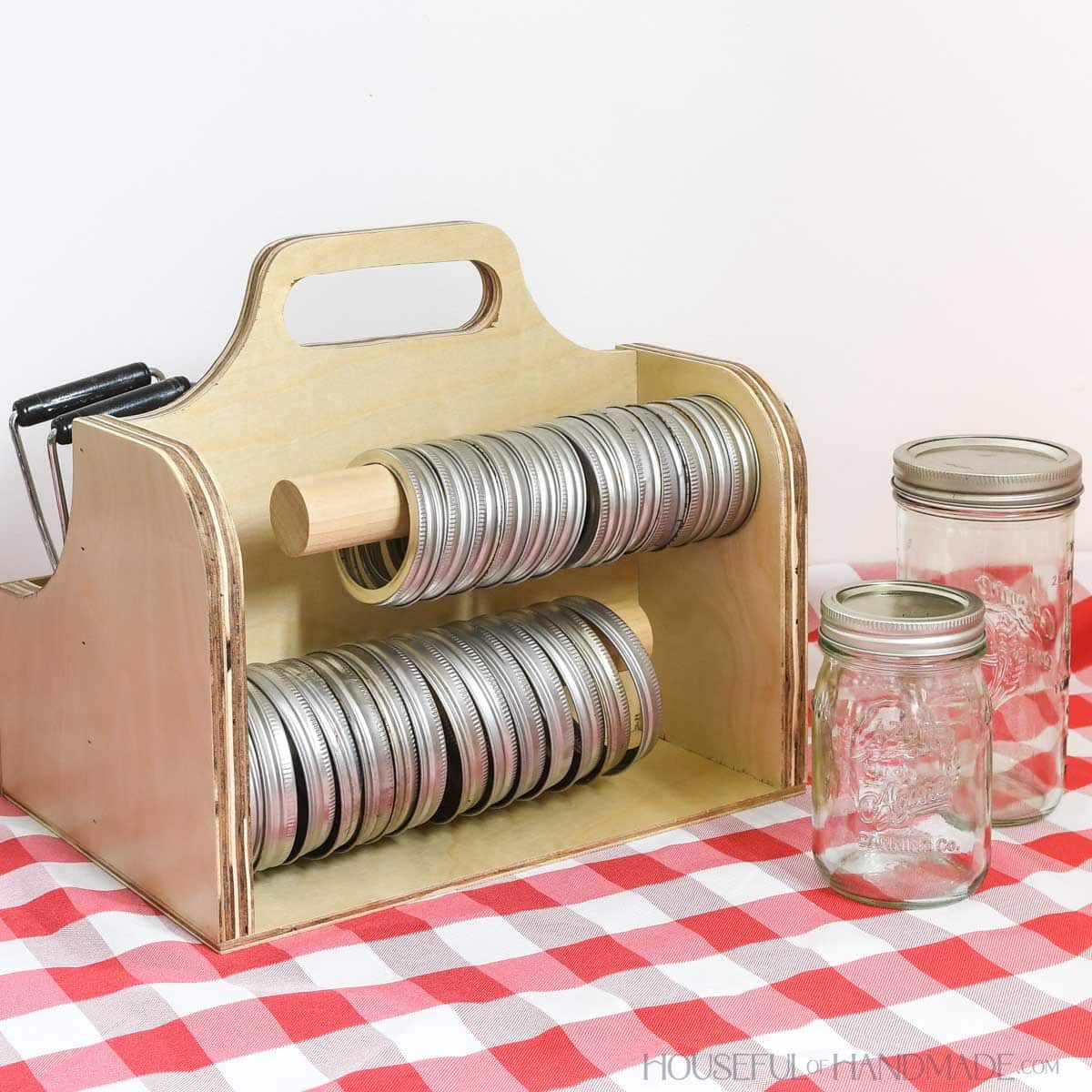 Two wood dowels on the back of the canning supply holder to hold regular and wide mouth rings. 