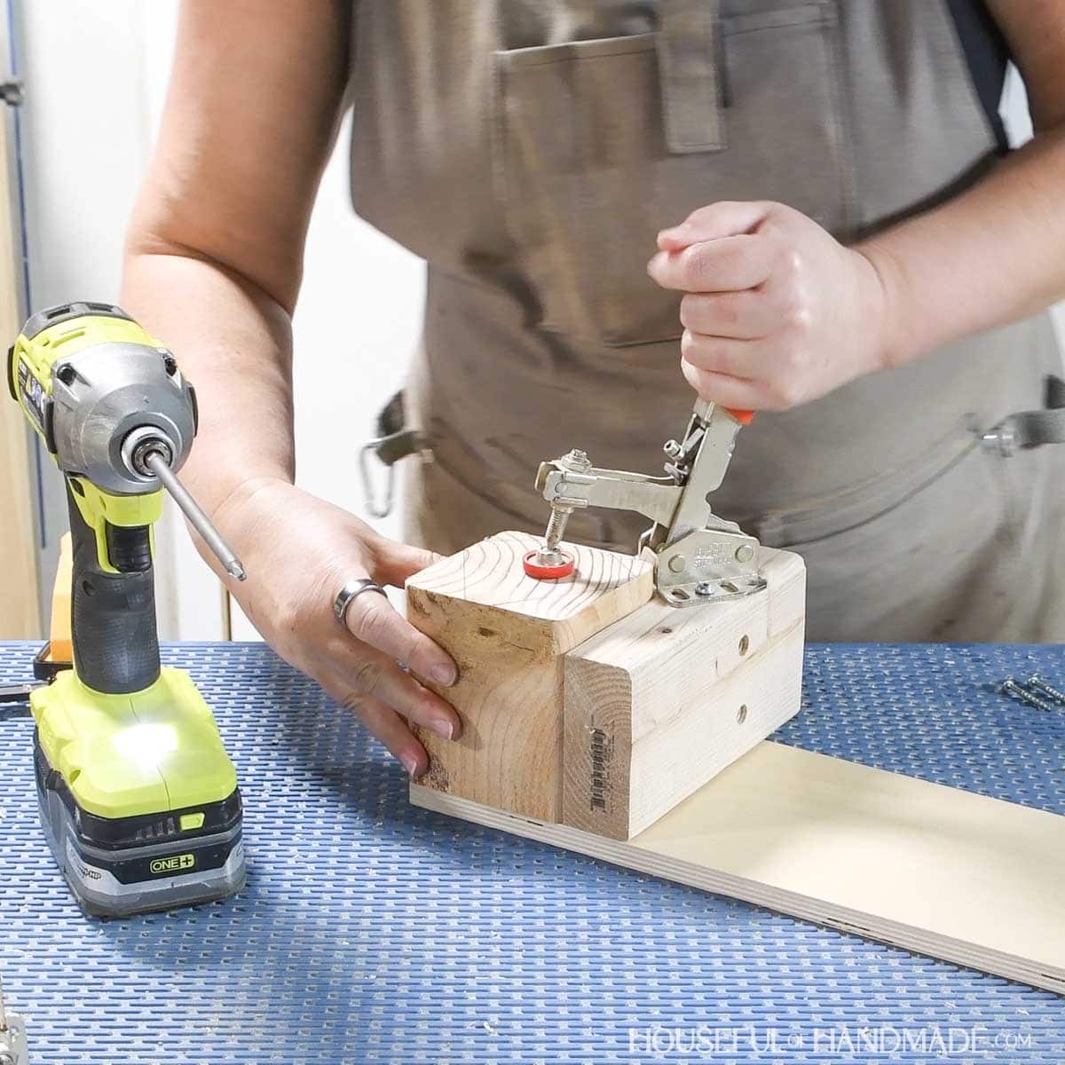 Securing block in miter saw jig.