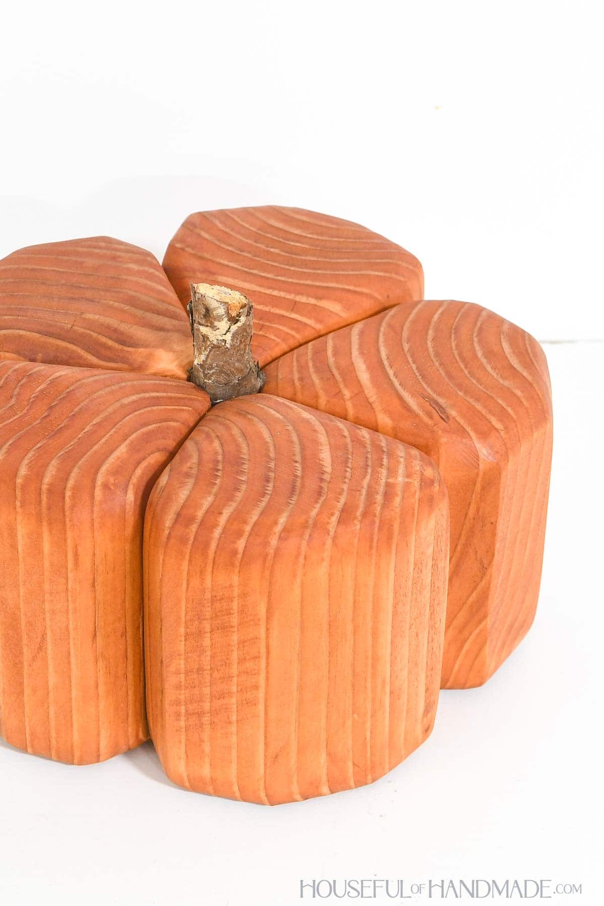 Cute chunky wood pumpkin with stick for a stem.